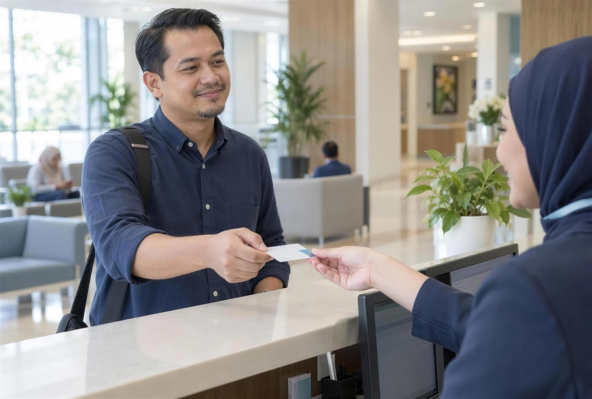 A man handing his medical card to a smiling receptionist at a private hospital counter